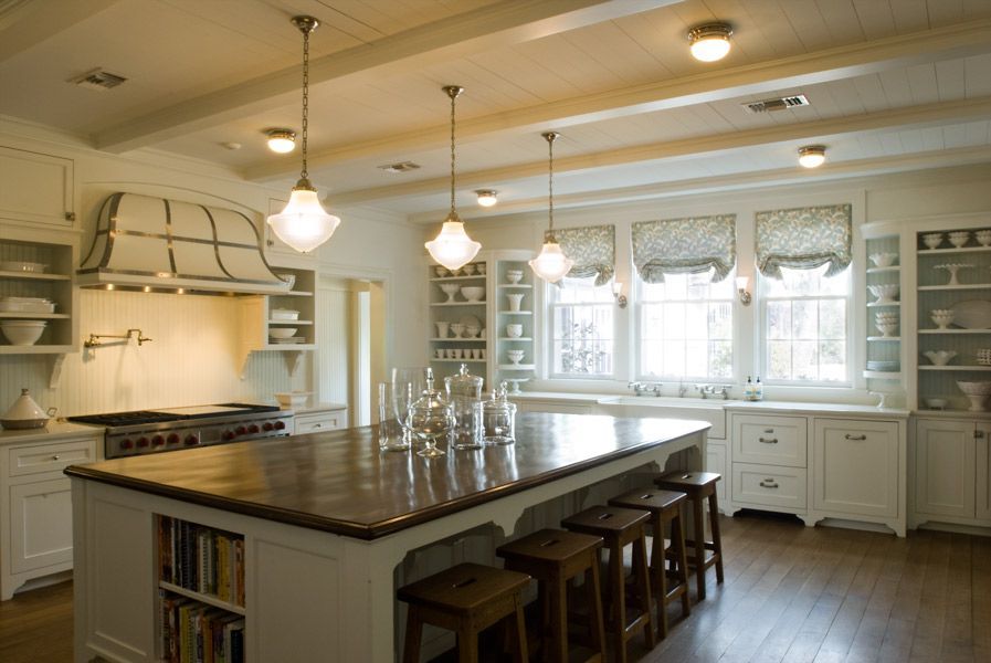 a kitchen with a large island and stools