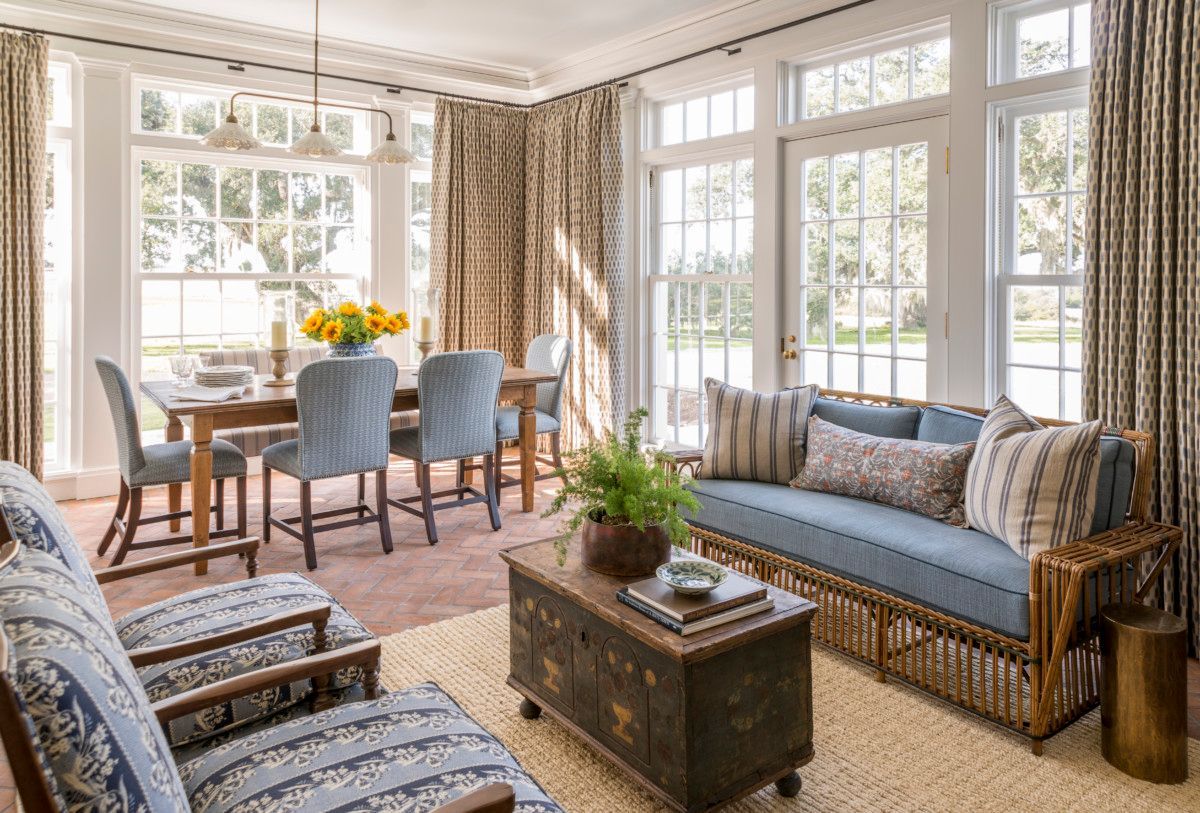 a living room with a couch , chairs , a table and a coffee table .