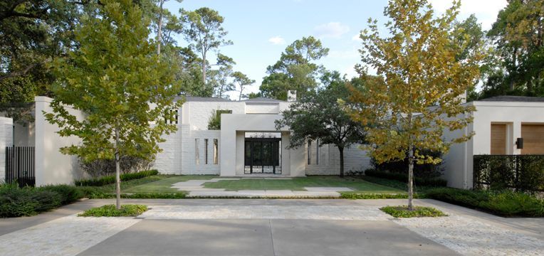 a large white house with trees in front of it