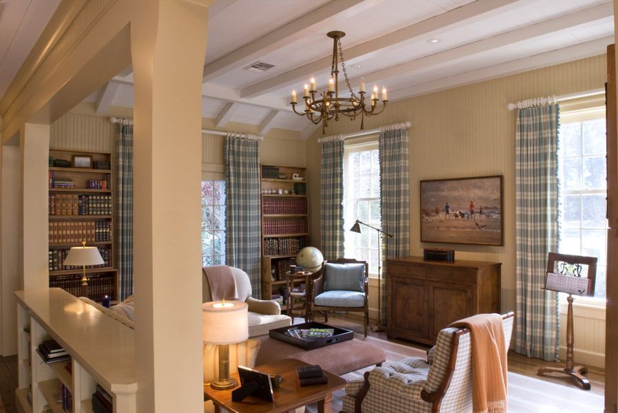 a living room with a chandelier hanging from the ceiling