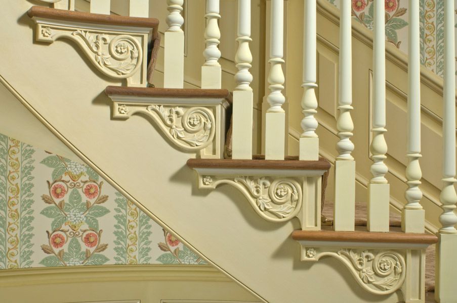 a staircase with a floral wallpaper behind it