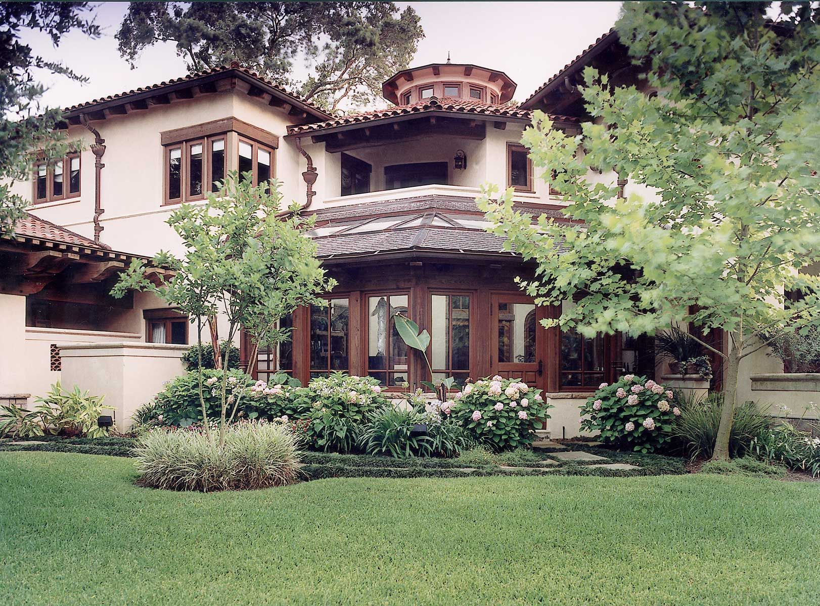 a large house with a lush green lawn in front of it