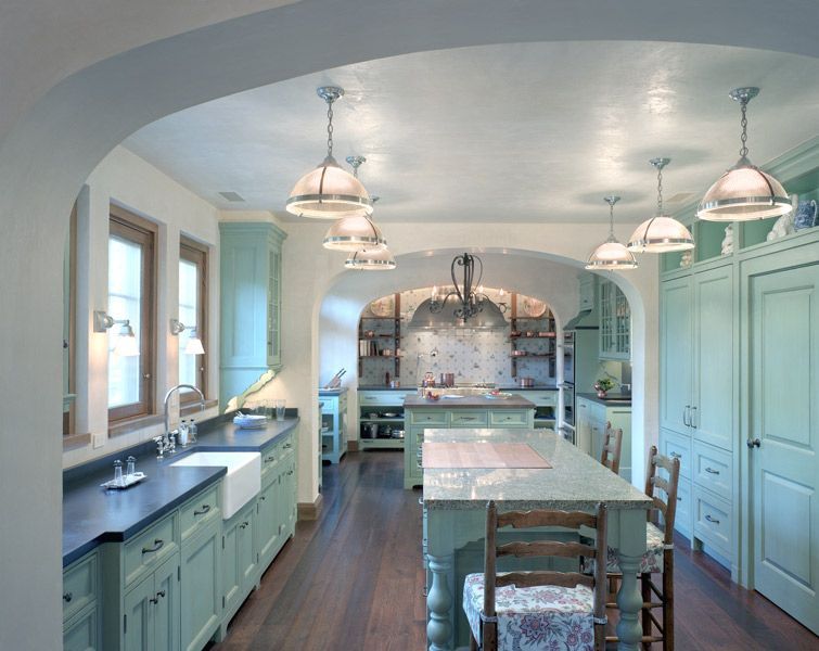 a kitchen with green cabinets and a large island