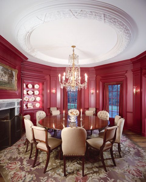 a dining room with a round table and chairs and a chandelier