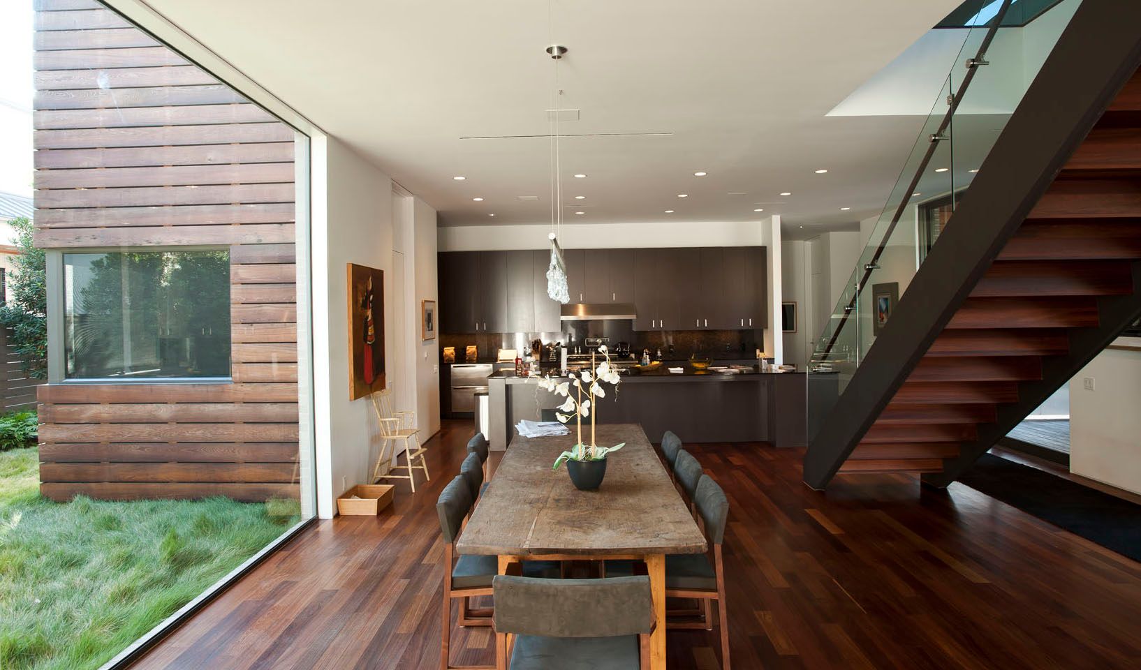 a dining room with a table and chairs and a staircase