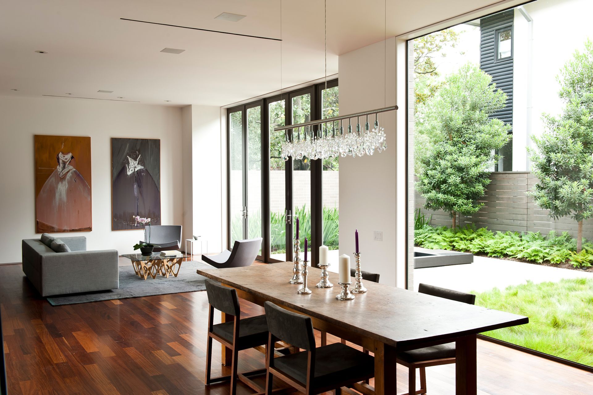 a living room with a dining table and chairs