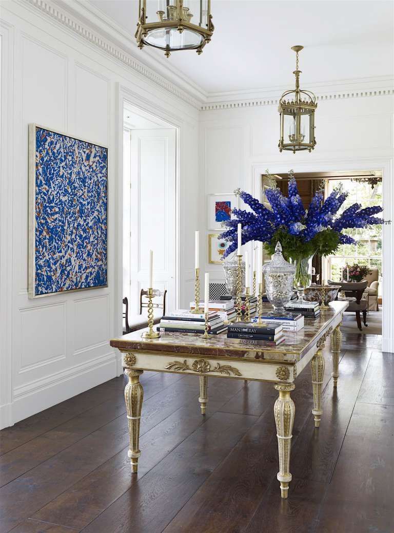 a table with a vase of blue flowers on it