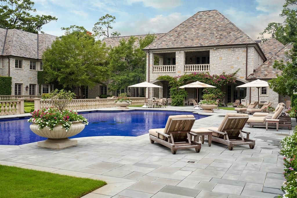 a large house with a large swimming pool in front of it