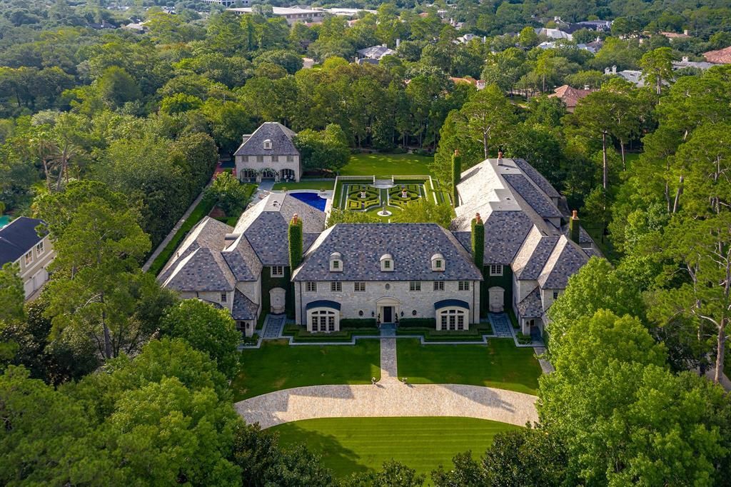 an aerial view of a large house surrounded by trees .