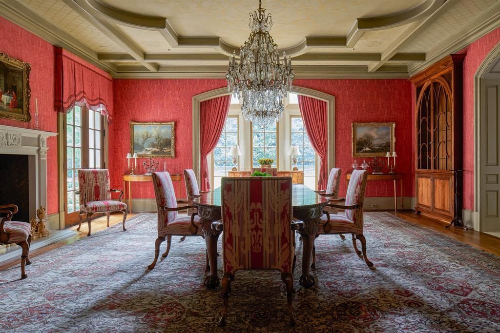 a large dining room with a table and chairs and a chandelier .