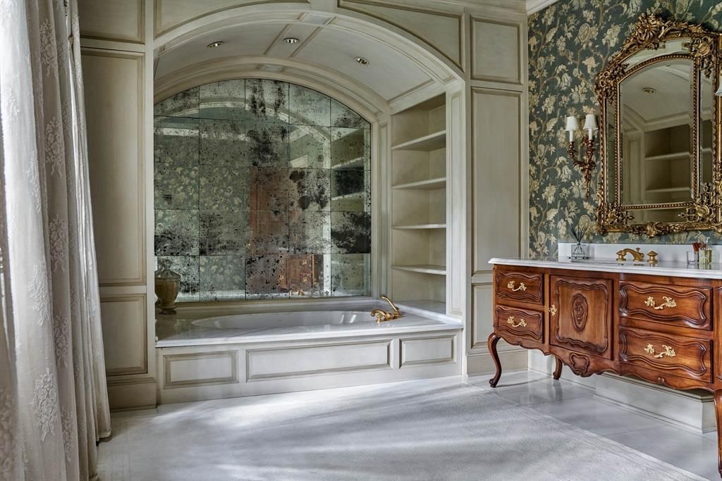 a bathroom with a bathtub and a mirror