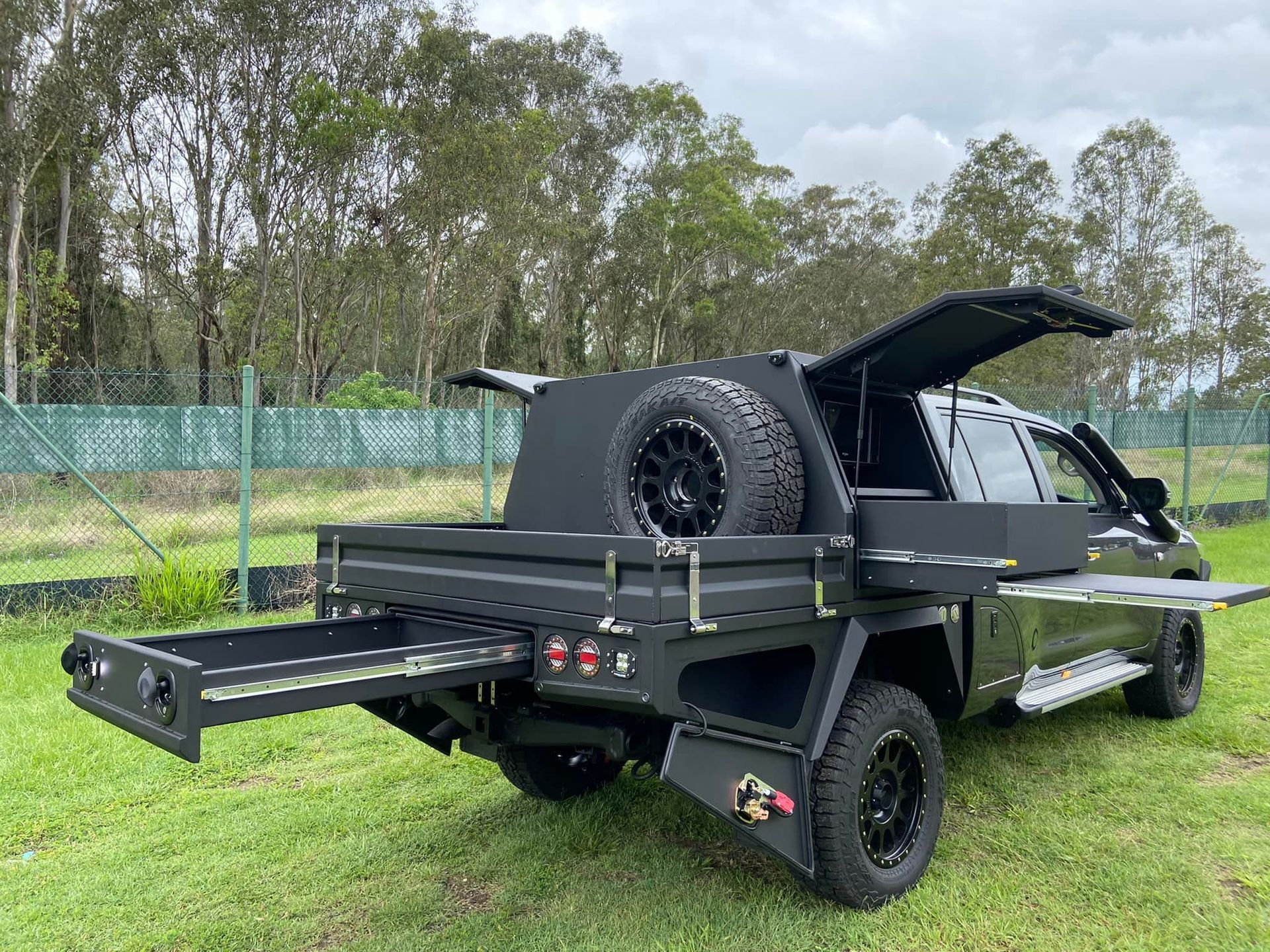 A White Vehicle is Parked in Front of a Building — Custom RV Creations & Repairs in Sumner, QLD