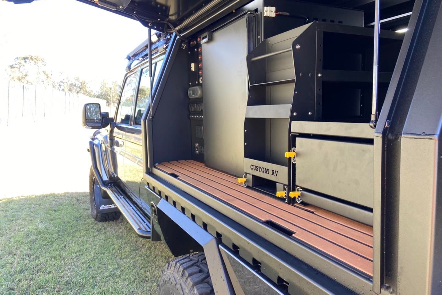 A Vehicle With a Surfboard on Top of It — Custom RV Creations & Repairs in Ipswich, QLD
