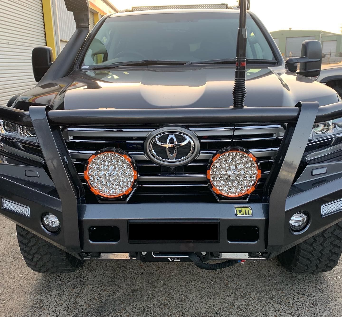 Black Toyota Land Cruiser with a custom front bumper, spotlights, and antenna. — Custom RV Creations & Repairs in Sumner, QLD