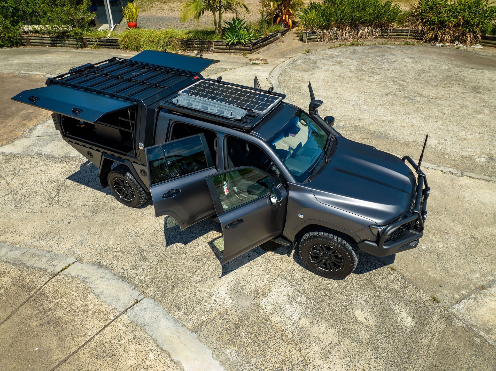 Grey Truck With Open Doors, Custom Canopy, Roof Rack, and Off-road Modifications. Outdoors on Concrete — Custom RV Creations in Sumner, QLD