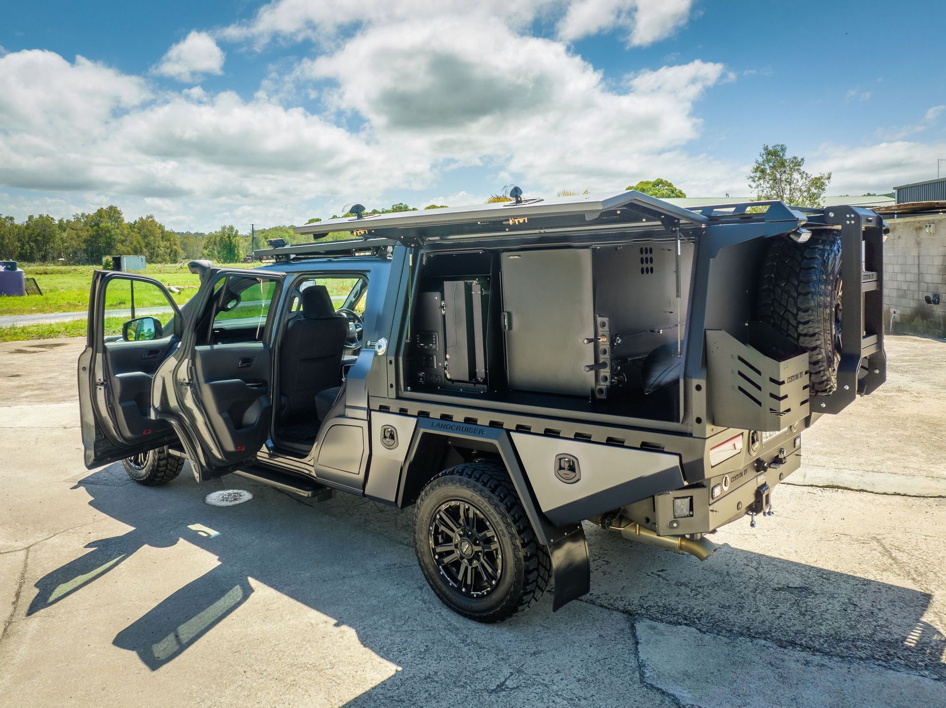 Grey Off-road Truck With Custom Camper Shell, Open Doors — Custom RV Creations in Sumner, QLD