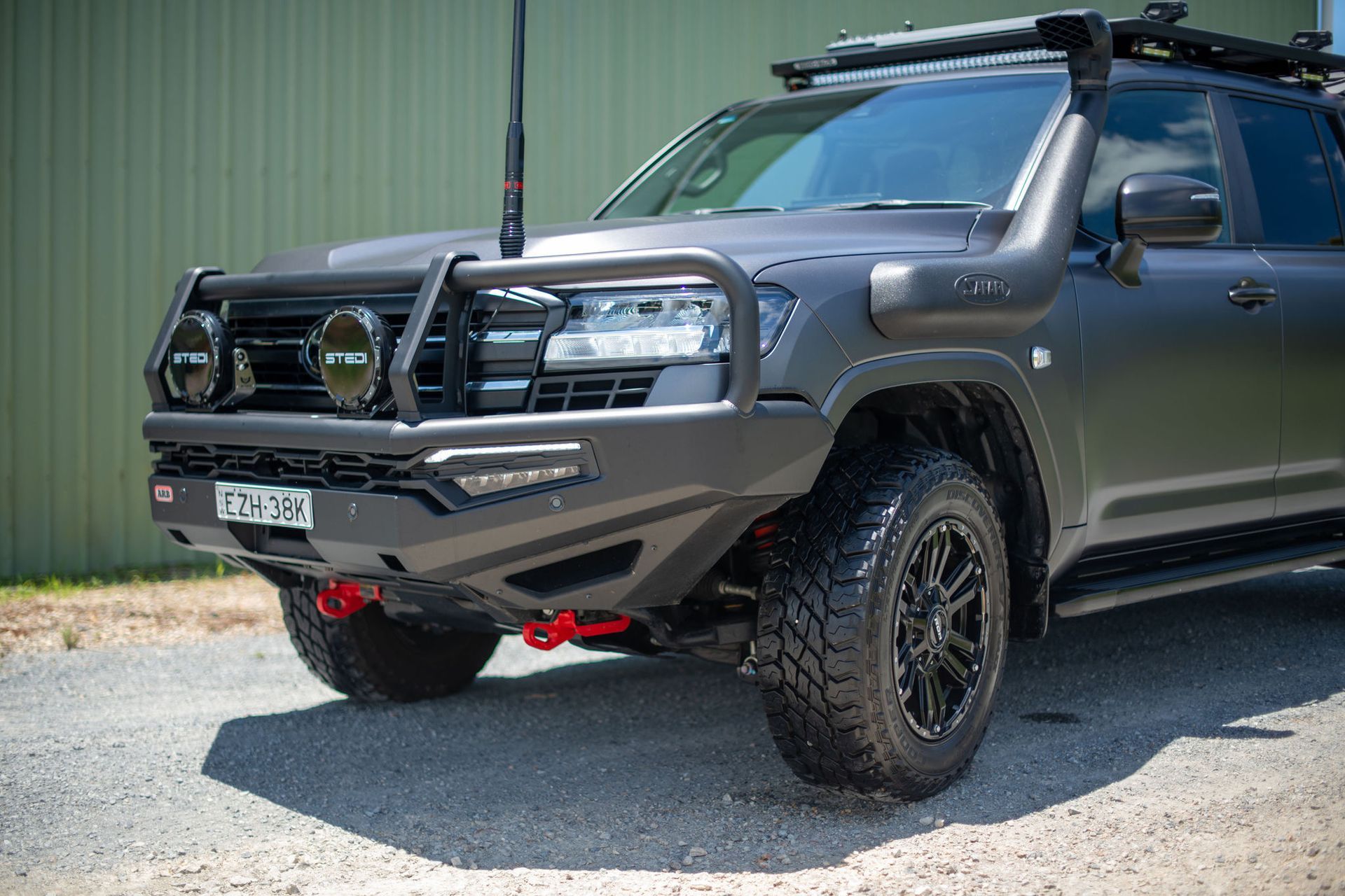 Grey Off-road SUV With a Black Bull Bar, Snorkel, and Roof Rack Parked Outdoors — Custom RV Creations in Sumner, QLD