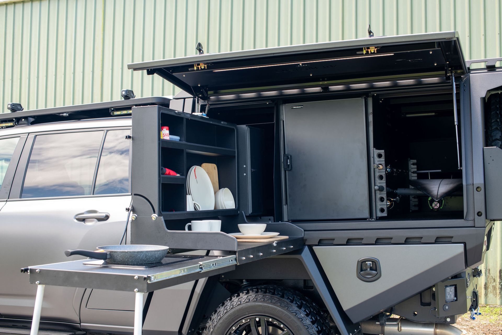 Truck Bed With Built-in Kitchen, Including a Fridge, Storage, and a Fold-out Cooking Surface — Custom RV Creations in Sumner, QLD