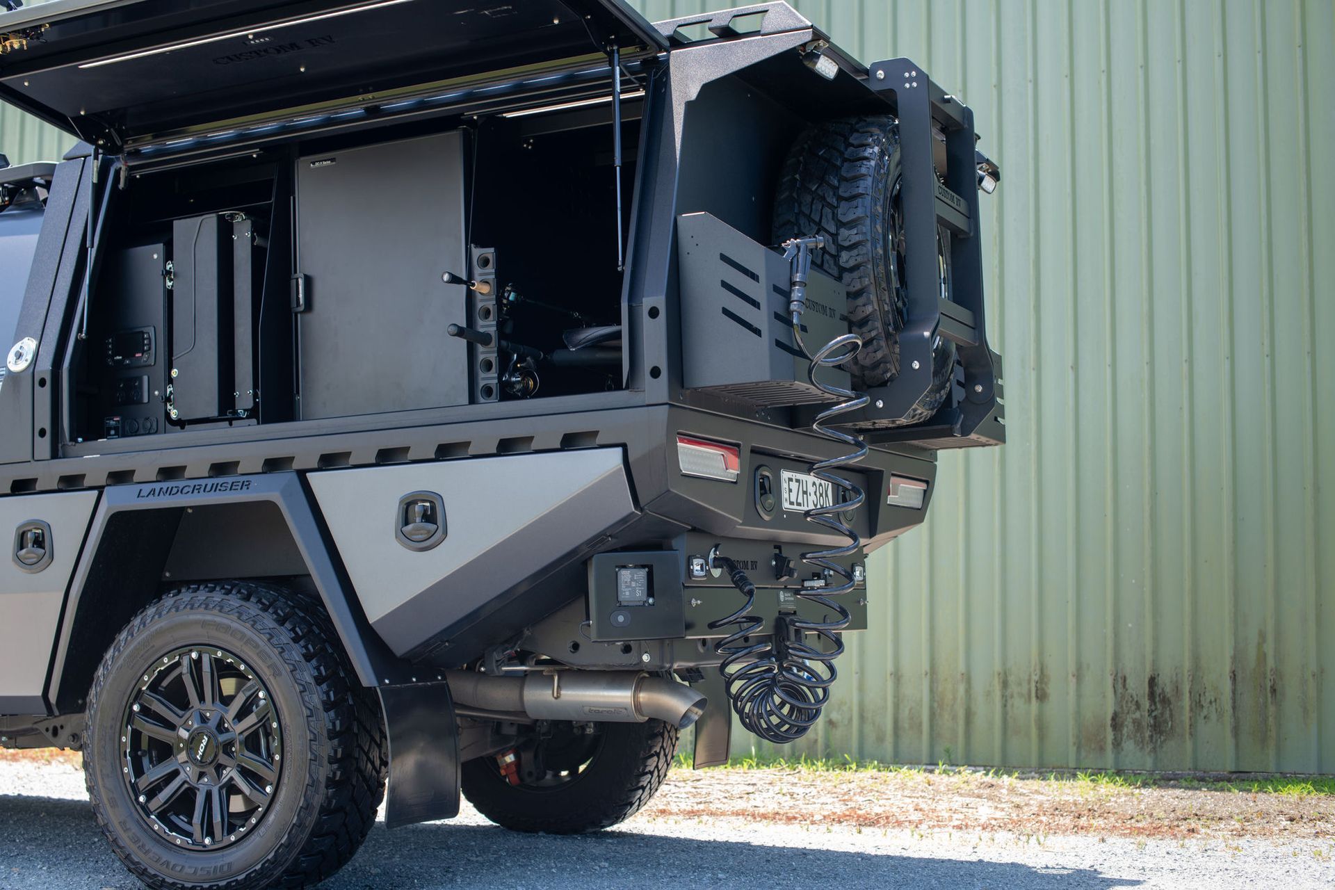 Black Utility Truck With Open Rear, Spare Tire, and Custom Storage — Custom RV Creations in Sumner, QLD