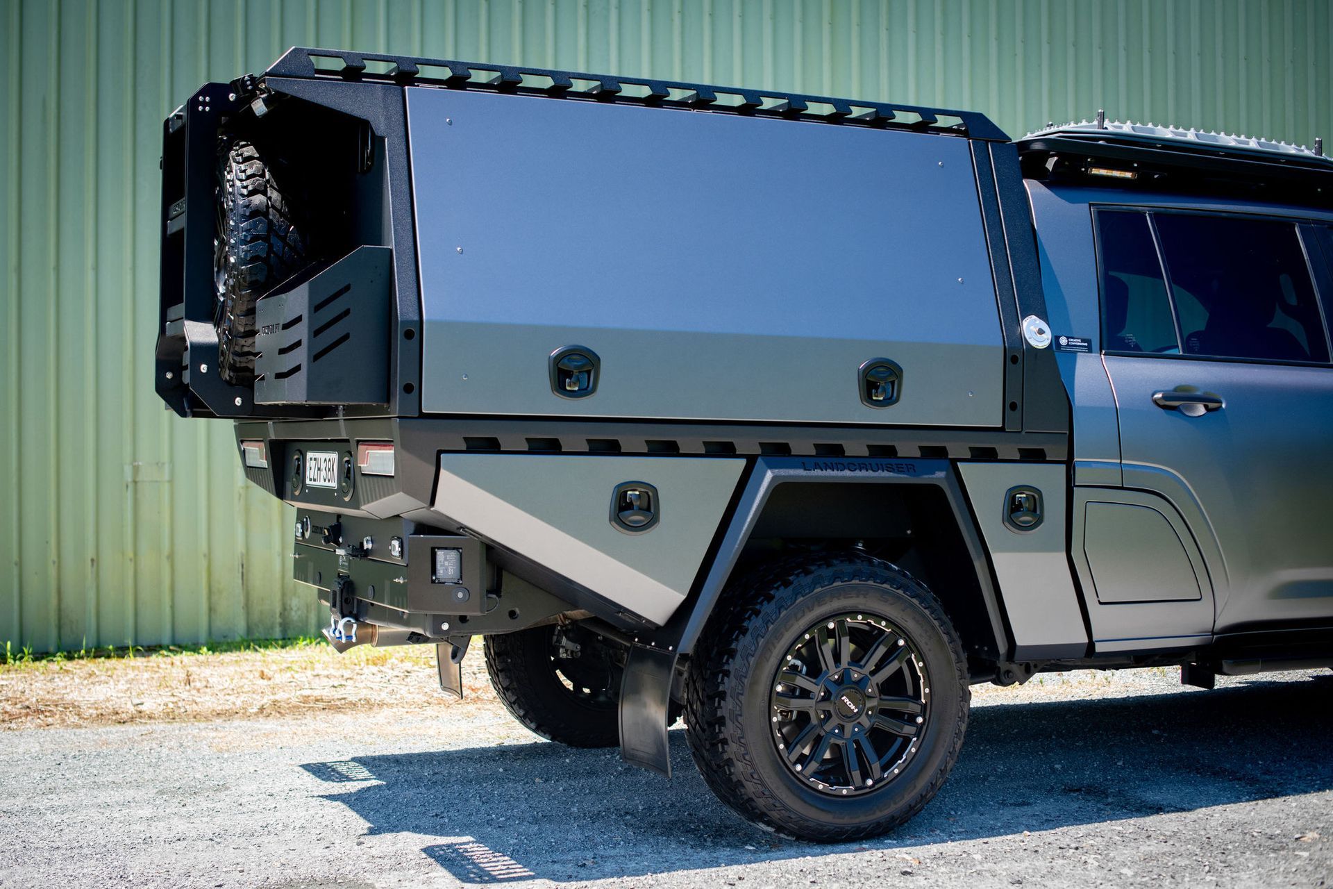 Grey SUV with Custom Black Utility Bed, Spare Tire Carrier, and Black Wheels — Custom RV Creations in Sumner, QLD
