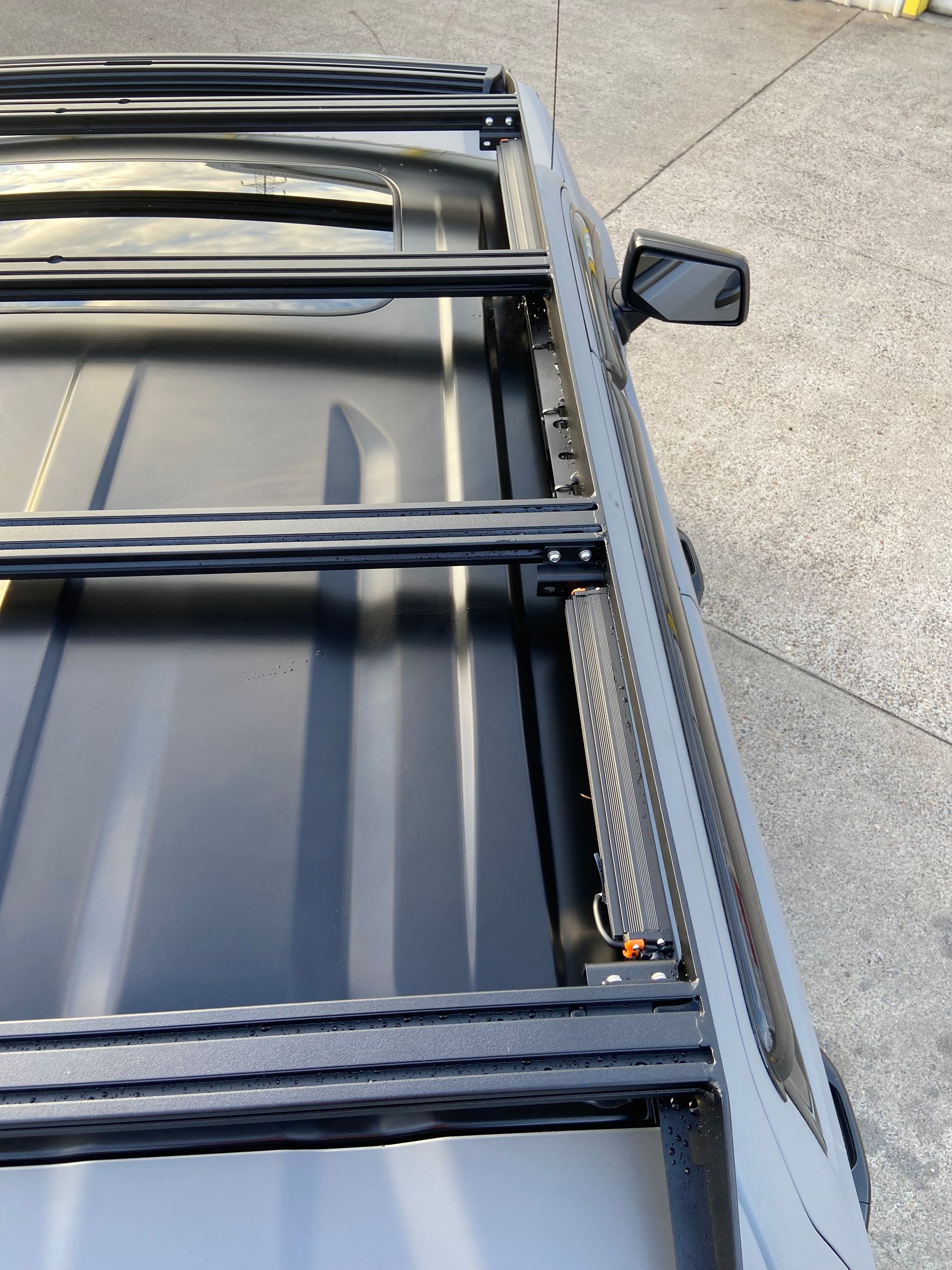 Black Roof Rack and LED Light Bar Installed on a Grey Vehicle Roof — Custom RV Creations in Sumner, QLD