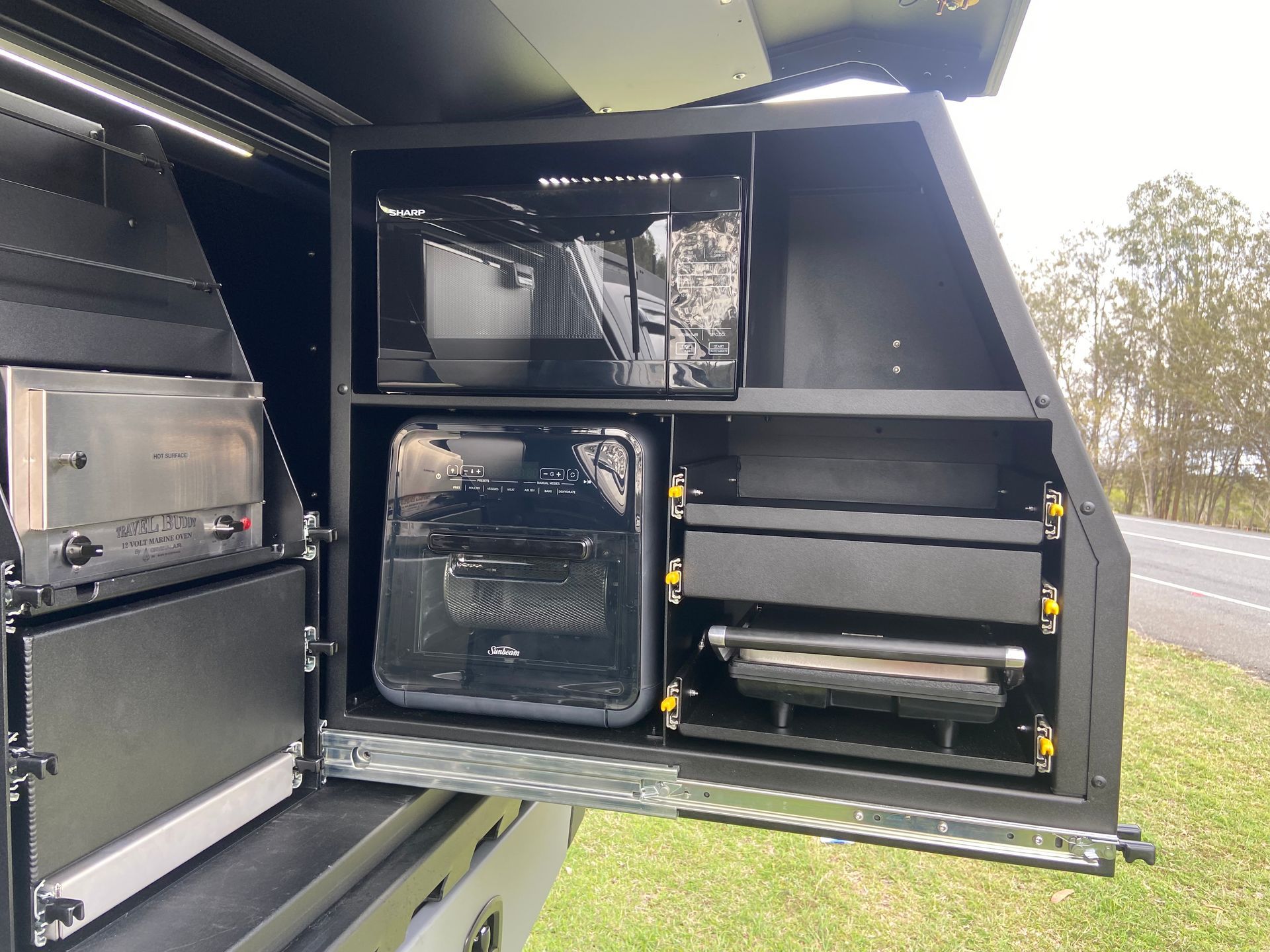 Black Truck Camper Storage With Microwave, Toaster, Air Fryer, and Grill — Custom RV Creations in Sumner, QLD