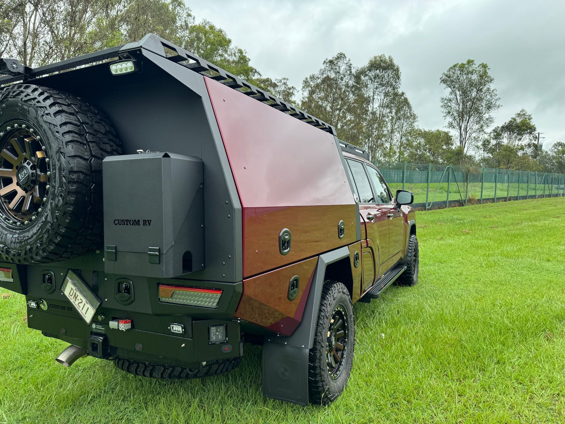 Dark Red and Black Custom Utility Truck on Green Grass — Custom RV Creations in Sumner, QLD