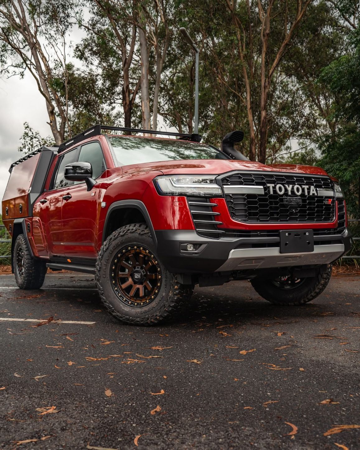 Red Toyota Land Cruiser Off-road Vehicle With Black Accents and a Roof Rack — Custom RV Creations in Sumner, QLD