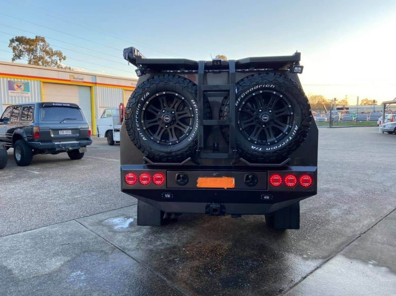 A Black Vehicle is Parked in a Parking Lot — Custom RV Creations & Repairs in Sumner, QLD