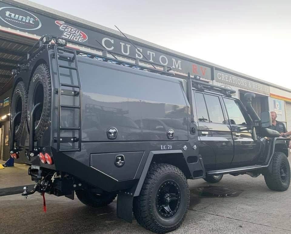A Black Vehicle is Parked in Front of a Building — Custom RV Creations & Repairs in Sumner, QLD