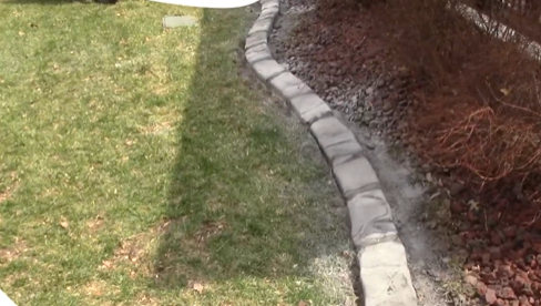 A green circle with a white silhouette of a shoe on it.