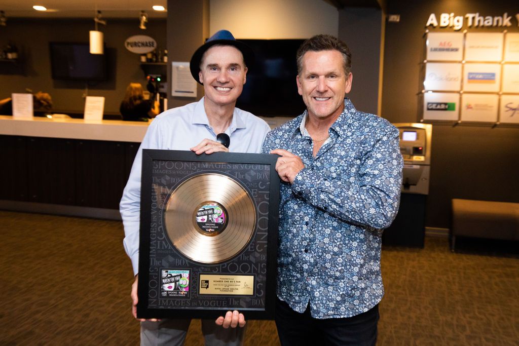 A group of people are standing in front of a bus.