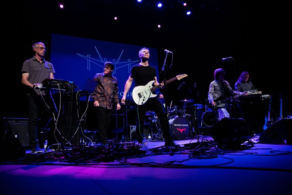 A group of men are playing instruments on a stage.