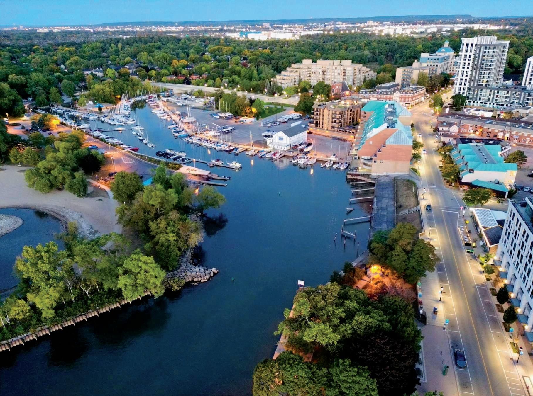 An aerial view of a large body of water surrounded by trees and buildings.