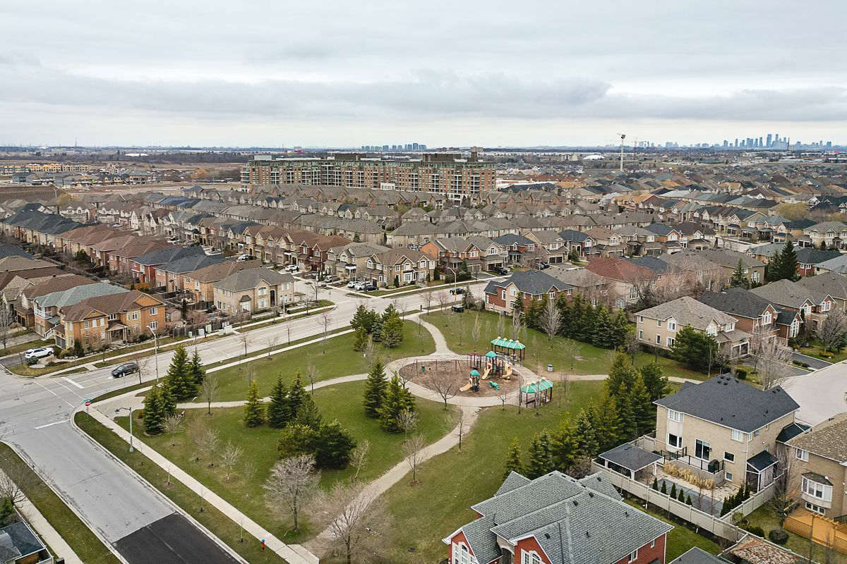 An aerial view of a residential area with a park in the middle of it.