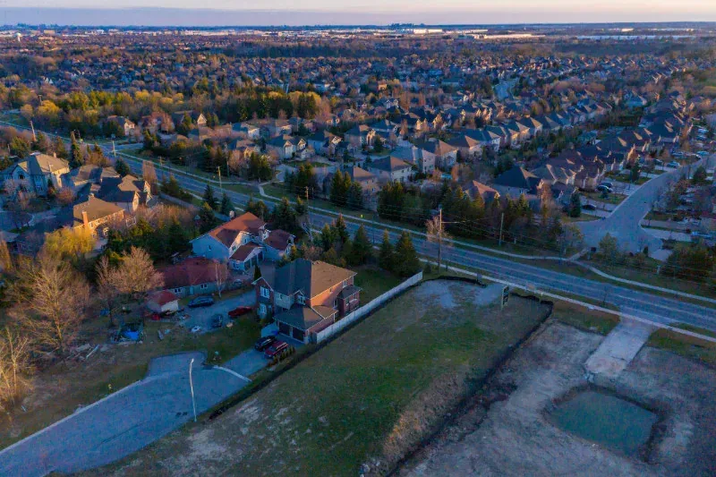 An aerial view of a residential area with a lot of houses and trees.