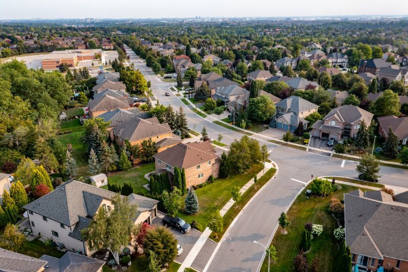 An aerial view of a residential neighborhood with lots of houses and trees.
