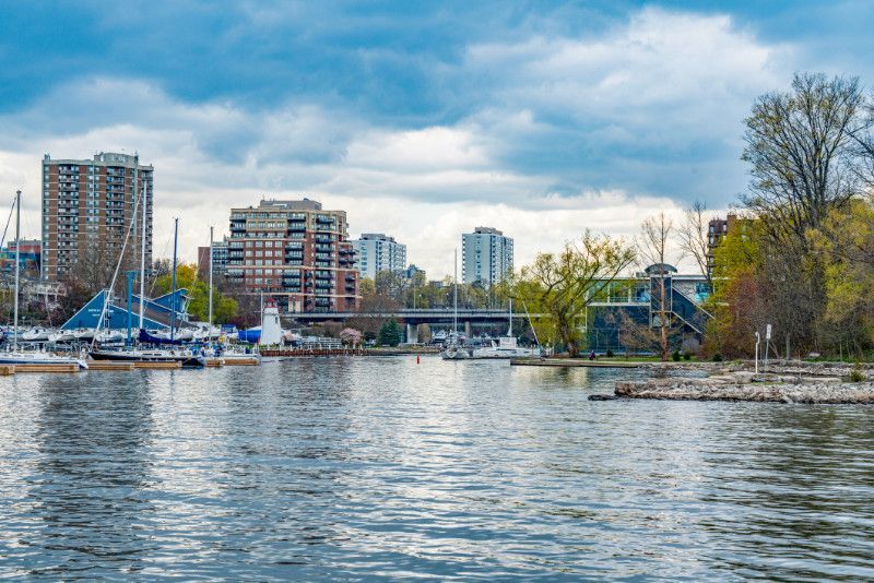 A large body of water with boats in it and a city in the background.