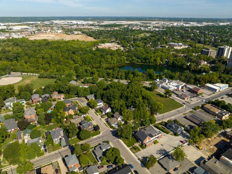 An aerial view of a residential area with a lake in the middle of it.