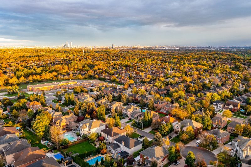 An aerial view of a residential neighborhood with a city in the background.