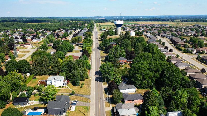 An aerial view of a residential area with a water tower in the background.