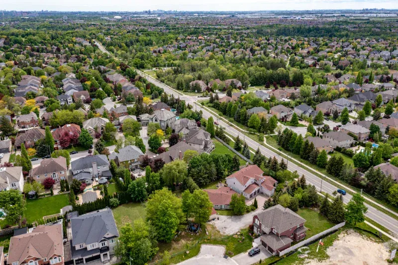 An aerial view of a residential area with lots of houses and trees.