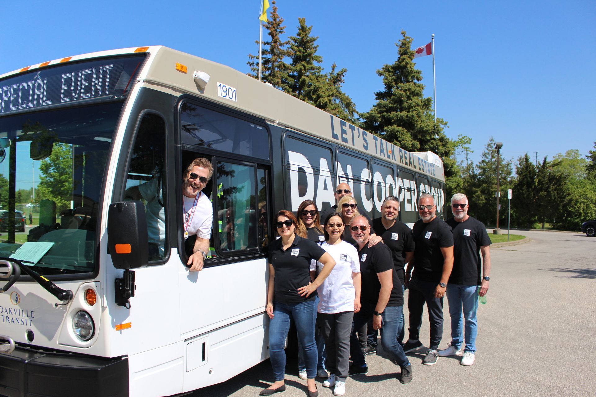 A large group of people are standing in the shape of a house.