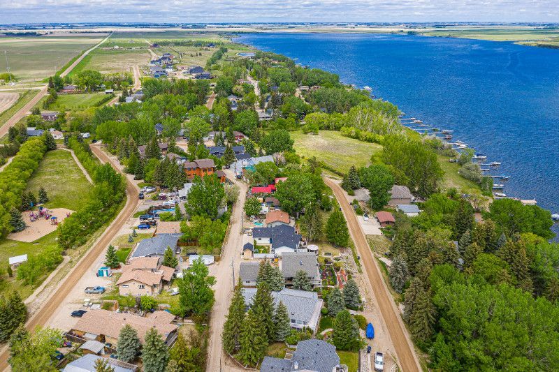 An aerial view of a small town next to a large body of water.