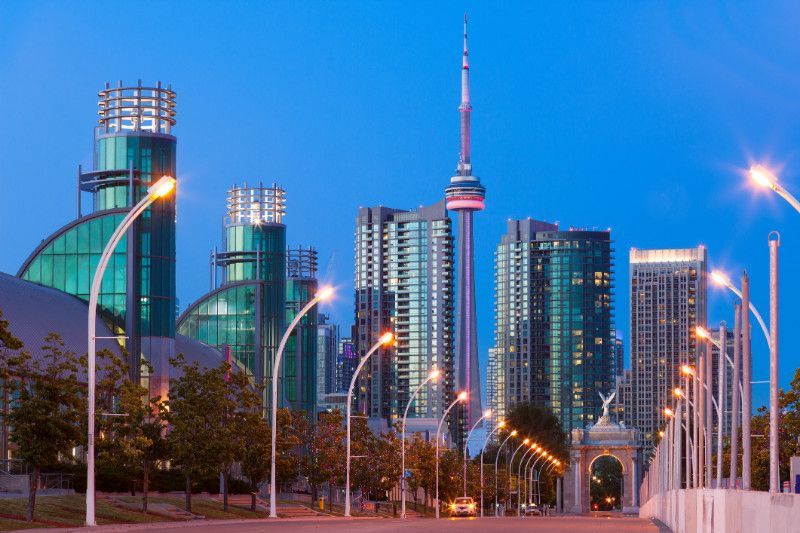 A city skyline with a tower in the middle of it