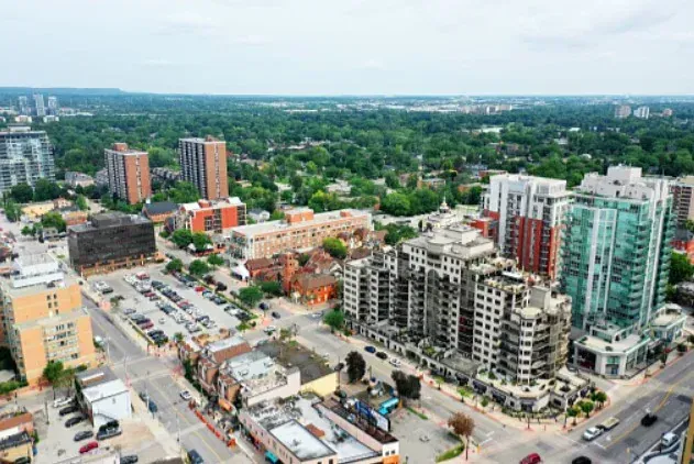 An aerial view of a city with lots of buildings and trees.