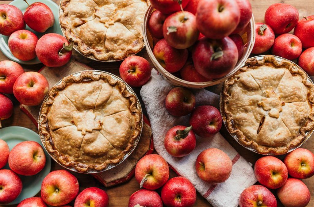 A dining room with a round table and blue chairs