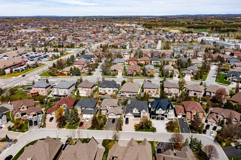 An aerial view of a residential area with lots of houses and trees.