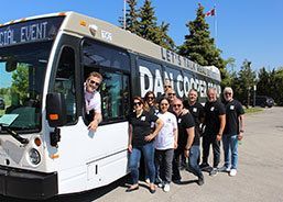 A group of people are standing in front of a bus.