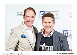 Two men in suits are posing for a picture together.